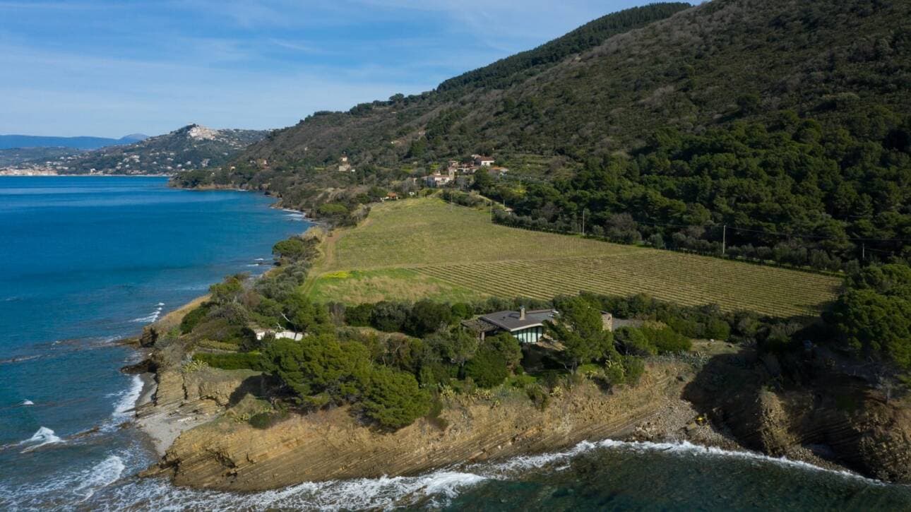 Coastal landscape with a house on a cliff by the sea.